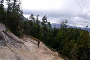 Hiker using rope assist along the Sea to Summit Trail near Squamish, BC